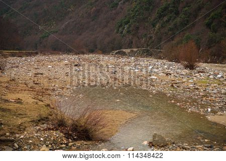 Bridge Across River With Green Waters, Snow And Ice Near Xanthi In Greece