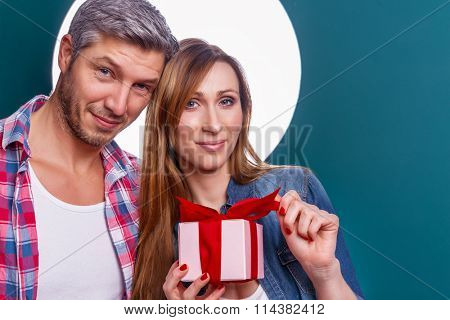 gift holding partnerhood hilding gift looking cam