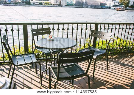 No Smoking sign on Chair and Desk/ Table set on the balcony beside the river Choa Praya River.