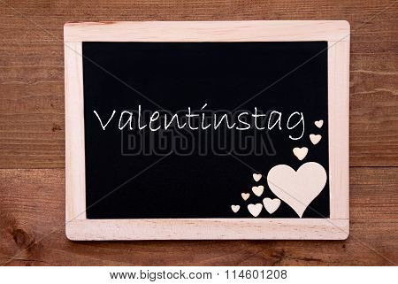 Blackboard With Wooden Hearts, Text Valentinstag Means Valentines Day