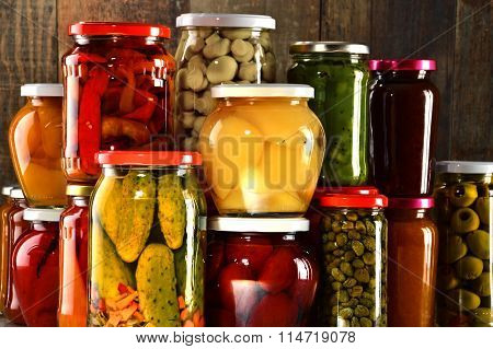 Jars With Pickled Vegetables, Fruity Compotes And Jams