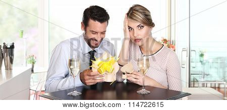Couple Exchanging Gifts On A Date, To The Surprise