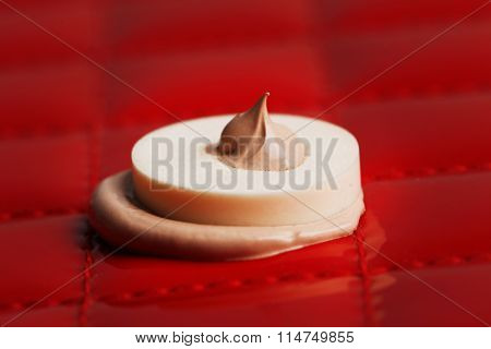 Makeup sponge with liquid foundation on abstract background