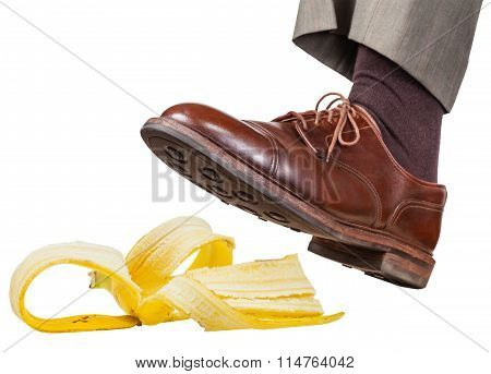 Foot In The Left Brown Shoe Slips On A Banana Peel