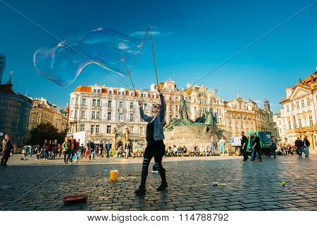 Unidentified woman makes soap bubbles in Old Town Square in Prague, Czech Republic