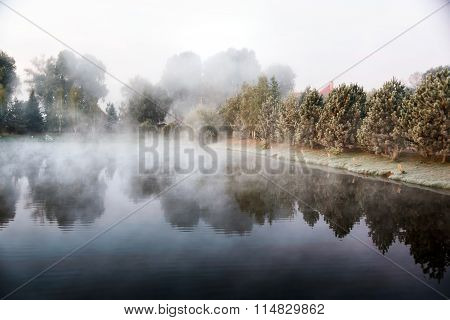 Mystical fog over the lake in the morning