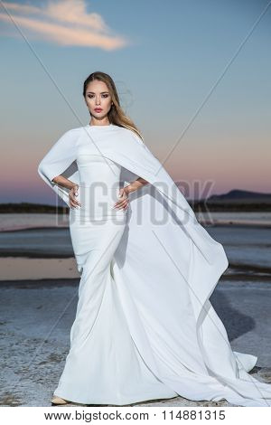 Stunning young woman in white dress 