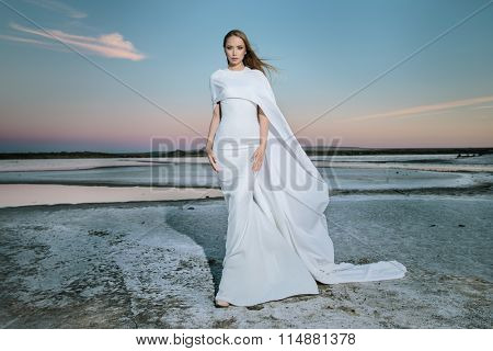 Stunning young woman in white dress 