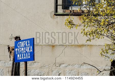 Close up of signboard along old house by path in the Turmachka mahala,  Plana village
