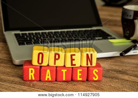 Open Rates written on a wooden cube in a office desk