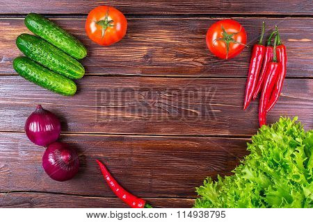 cucumbers, hot pepper, lettuce leaves, onion, and fresh tomatoes on