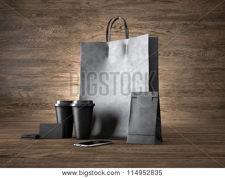 Set of shopping bag, two coffee cups, black business cards and generic design smartphone. 3d render