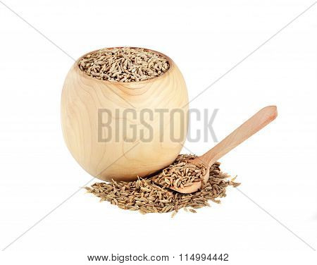 dried cumin in a wooden jar