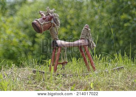 hand made wooden horse on green grass