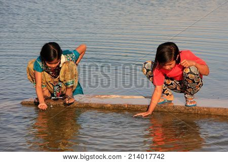 Khichan, India - February 12: Unidentified Girls Drink Water From Reservoir On February 12, 2011 In