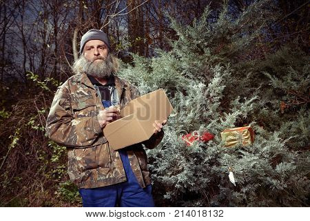 Homeless older men celebrating christmas in park with gifts