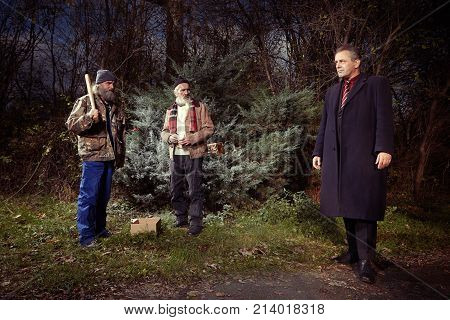 Two homeless older men attacking manager man in park
