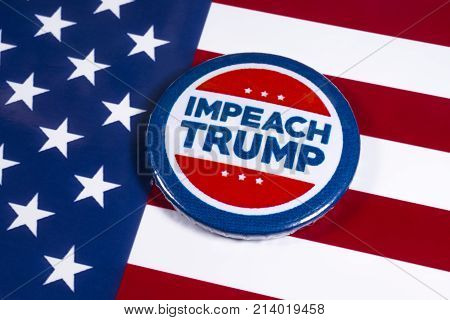 LONDON UK - NOVEMBER 15TH 2017: Anti-Tump badge over an American flag background on 15th November 2017.