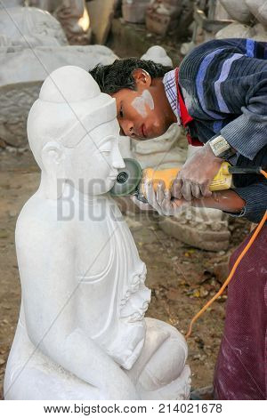 Mandalay, Myanmar - December 29: Unidentified Man Works On A Statue Near Mahamuni Pagoda On December
