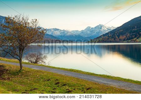 Lake Resia at sunset in the Italian eastern Alps