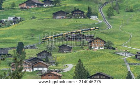 Switzerland - May 2017: Alpine express rushing through scenic valley in Switzerland