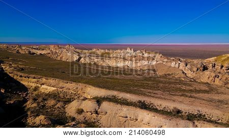 Panorama view to Aral sea from the rim of Plateau Ustyurt at sunset in Karakalpakstan Uzbekistan