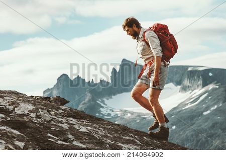 Man hiking in mountains with backpack Travel sport lifestyle concept active weekend summer vacations wild trek