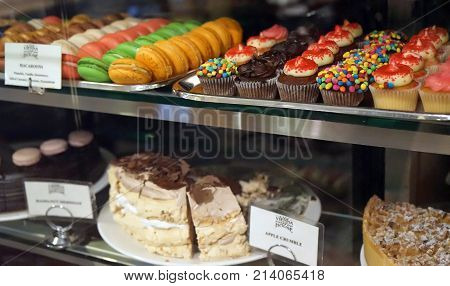 Sydney Australia - November 03 2017: Pastry shop window display for Old Vienna Coffee House with variety of cupcakes muffins macaroons cakes
