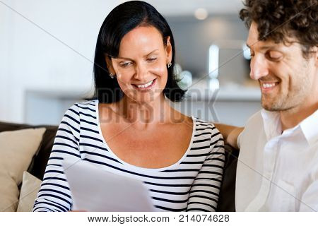 Couple with papers in their living room