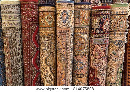 Variety of colorful Persian and Indian carpets on oriental bazaar