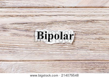 BIPOLAR of the word on paper. concept. Words of BIPOLAR on a wooden background.