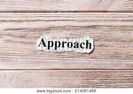 APPROACH of the word on paper. concept. Words of APPROACH on a wooden background.