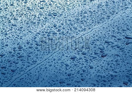 Rain Drops On Blue Color Metal Car Surface.
