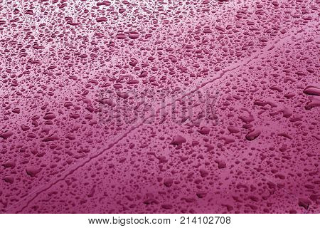 Rain Drops On Pink Color Metal Car Surface.
