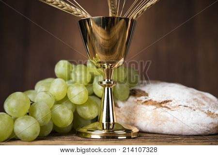 Eucharist symbol of bread and wine, chalice and host, First communion background