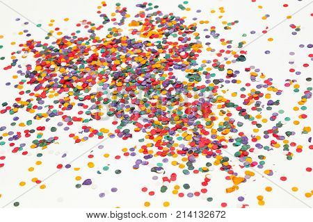 Colorful confetti over white background. Christmas or birthday concept