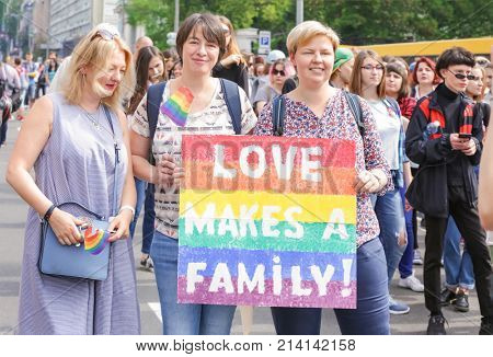 KYIV, UKRAINE - JUNE 18, 2017: Women with rainbow agitative poster on gay pride outdoors