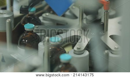 Pharmaceutical industry. Production line machine conveyor at factory with bottles. pharmaceutical production of liquid pharmaceuticals HD
