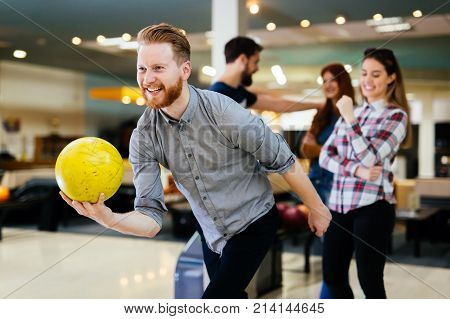 Friends having fun while bowling and speding time together