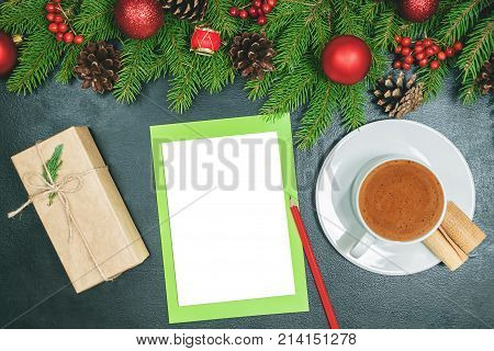 Christmas background or Xmas card with decorations fir gift box and ornamen. Space for Holiday Greetings. Top view. Goal planning winter holiday. Black backtop