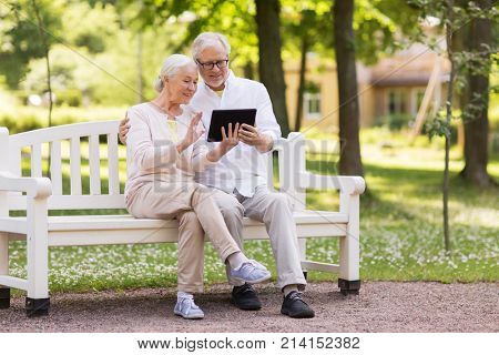 old age, technology and people concept - happy senior couple with tablet pc computer having video chat at summer park