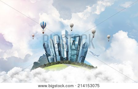 Green flying island among clouds with urban view of towers and skyscrapers. Flying aerostates and blue cloudy skyscape on background. 