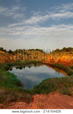 This lake was a Bauxite (mineral used to produce aluminium) mine until 1976 when it has been abandoned due to the infiltration of salted water coming from the sea that has created the lake. It is located in Otranto a city of the Puglia region Italy. 