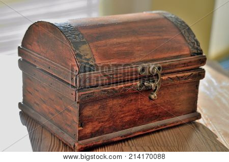 vintage old treasure chest of wood and iron lighting with the sun to the money for good luck