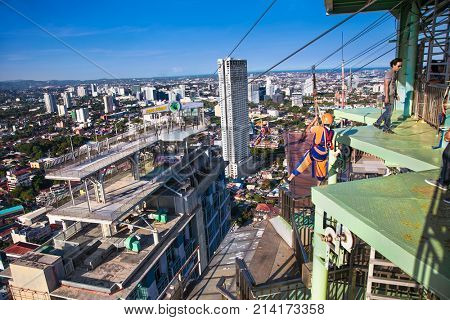 CEBU, PHILIPPINES-MARCH 25, 2016: Hang Higher- The world's first urban sky zip at  Crown Regency on March 25, 2016. Cebu city. Philippines. It's zip line goes between two buildings at the 37th floor.