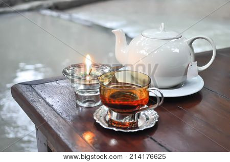 tea pot a glass of tea and candle