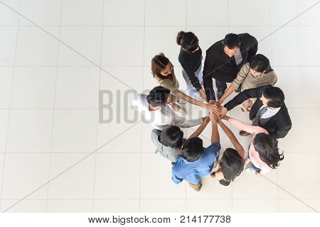 top view of business multi-ethnic partners teamwork team join hand together at office synergy concept copy space