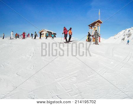 Paradiski, France - January 7, 2014: Ski resort slopes with skiers in French Alps