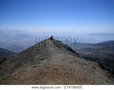 sitting on the highest peak of the mountain