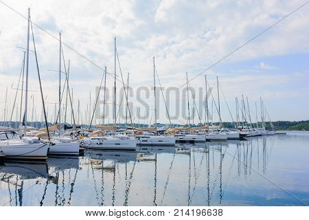 Yachts and boats parked in harbour, marina, in the morning at sunrise, harbor of Sibenik, Croatia